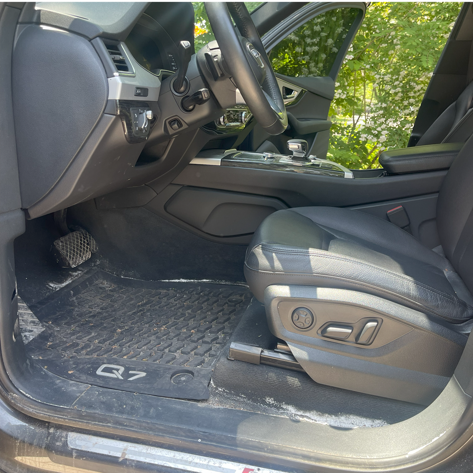 Before interior detailing – dirty Audi Q7 floor mat with visible salt stains and debris